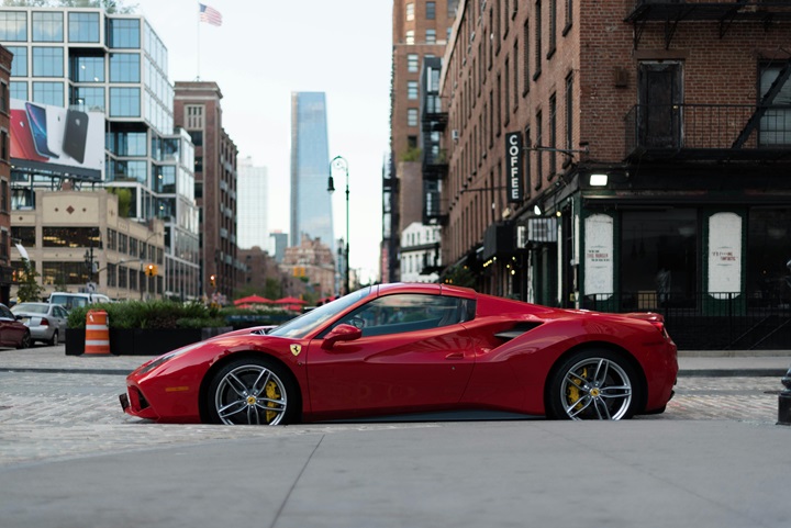Ferrari parked on the side of a road in a city