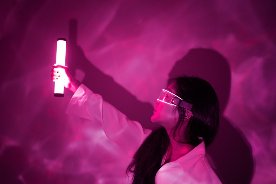 Woman holding fluorescent tube light