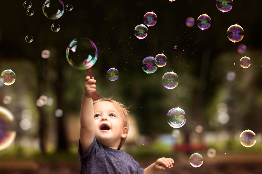 Child pointing at bubbles